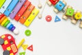 Children`s toys made of natural wood on white background. Multi-colored pyramid, train, constructor, xylophone in rainbow colors. Royalty Free Stock Photo