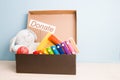 children`s toys in an open cardboard box with a lid on a light wooden table Royalty Free Stock Photo