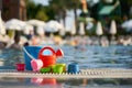 children's toys bucket, watering can on the background of the pool Royalty Free Stock Photo