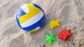 Children`s toys on the sand, soccer ball and colorful sand molds Royalty Free Stock Photo