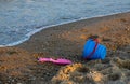 Children's toys on a sandy beach, blue sky and the sea in the background Royalty Free Stock Photo