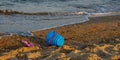 Children's toys on a sandy beach, blue sky and the sea in the background Royalty Free Stock Photo