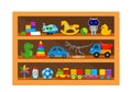 Children`s toys on the shelf. Constructor, train, doll, cars, dinosaur skeleton, dragon, rocket and balls