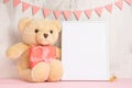 Children`s toys, a teddy bear and a frame on a light wall background, for design, layout. Baby shower