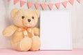 Children`s toys, a teddy bear and a frame on a light wall background, for design, layout. Baby shower