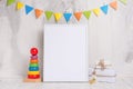 Children`s toys, with a white frame The frame on a light background of the wall with children`s signs, for design, layout. Baby