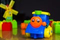 children`s train on wooden table surrounded by toys