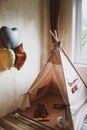 Children`s wigwam for a beige boy. In the nursery. Royalty Free Stock Photo