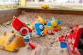 Children's wooden sandbox with various toys for the game. Royalty Free Stock Photo