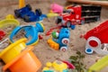 Children's wooden sandbox with various toys for the game. Royalty Free Stock Photo