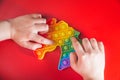 Children`s wooden toy. The child collects a sorter. Educational logic toys for kid`s. Children`s hands close-up. Montessori Gam