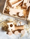 Children`s wooden toys. Children wooden train with wagons in the box with sawdust. Natural wood construction set