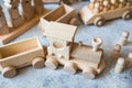 Children`s wooden toys. Children wooden train with wagons and cars. Natural wood construction set