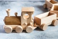 Children`s wooden toys. Children wooden  train with wagons. Natural wood construction set. Educational equipment Royalty Free Stock Photo