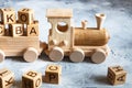 Children`s wooden toys. Children wooden  train with wagons. Natural wood construction set. Educational equipment Royalty Free Stock Photo