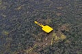 Children\'s yellow plastic shovel floating on water