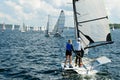 Children Sailing small sailboat stern view on an inland waterw Royalty Free Stock Photo