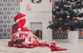 Children in santa hats near christmas tree, wait for holidays Royalty Free Stock Photo