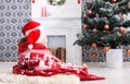 Children in santa hats near christmas tree, wait for holidays Royalty Free Stock Photo