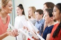 Children In School Choir Being Encouraged By Teacher Royalty Free Stock Photo