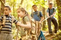 Children scouts and father explore the beautiful forest Royalty Free Stock Photo