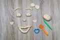 Children sculpt from salt dough, clay, plasticine on a wooden background. Children`s creativity. Manual creativity