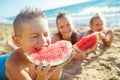 Children at sea. A group of children are eating a watermelon. Royalty Free Stock Photo