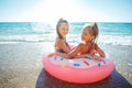 Children at sea play merrily. Two sisters run, jump on the beach in summer. Royalty Free Stock Photo