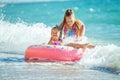 Children at sea play merrily. Two sisters run, jump on the beach in summer. Royalty Free Stock Photo