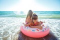 Children at sea play merrily. Two sisters run, jump on the beach in summer. Royalty Free Stock Photo