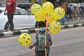 Children Selling Smiley Balloon On Streets