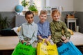 Children separating rubish in to three bins. Royalty Free Stock Photo