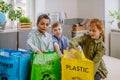 Children separating rubish in to three bins. Royalty Free Stock Photo