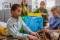 Children separating rubish in to three bins. Royalty Free Stock Photo