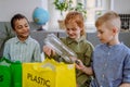 Children separating rubish in to three bins. Royalty Free Stock Photo