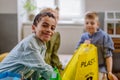 Children separating rubish in to three bins. Royalty Free Stock Photo