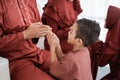 Children shake hands to apologize while celebrating Lebaran