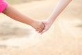 Children shaking hands with blur background,friendship,Girl hold one& x27;s hands walking in road blur background Royalty Free Stock Photo