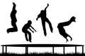 Children silhouettes jumping on garden trampoline