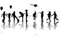 Children silhouettes playing with a kite and balloons Royalty Free Stock Photo