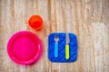 children silverware plastic cutlery wooden boards brown background Royalty Free Stock Photo