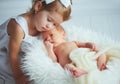 Children sister and brother newborn baby on a light