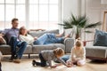 Children siblings playing drawing together while parents relaxin Royalty Free Stock Photo