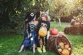 Children sister and brother with pumpkin dressed like skeleton and witch for Halloween party. Halloween portrait of Royalty Free Stock Photo