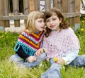 Children sister girls whisper in ear meadow spring Royalty Free Stock Photo