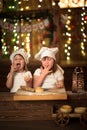 Children sisters cook with a rolling pin to stretch concept of