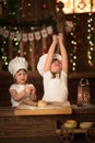 Children sisters cook with a rolling pin to stretch concept of