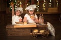 Children sisters cook with a rolling pin to stretch concept of