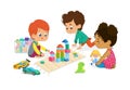 Children sit in circle and play with toys in the kindergarten classroom, play with wooden toy blocks, cars, doll and Royalty Free Stock Photo