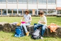 Children sit on in the school yard and eat apples and sandwiches. Snack during break time during class Royalty Free Stock Photo